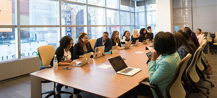 business decision makers in conference room with laptops
